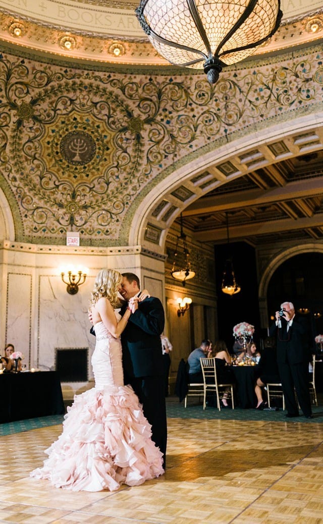 Maggie Bride Laurie wearing a blush fit-and-flare wedding dress.