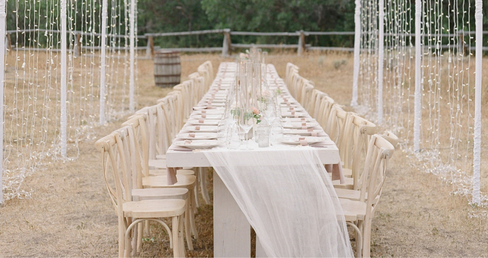 Outdoor Wedding Table Setting Under Fairy Lights