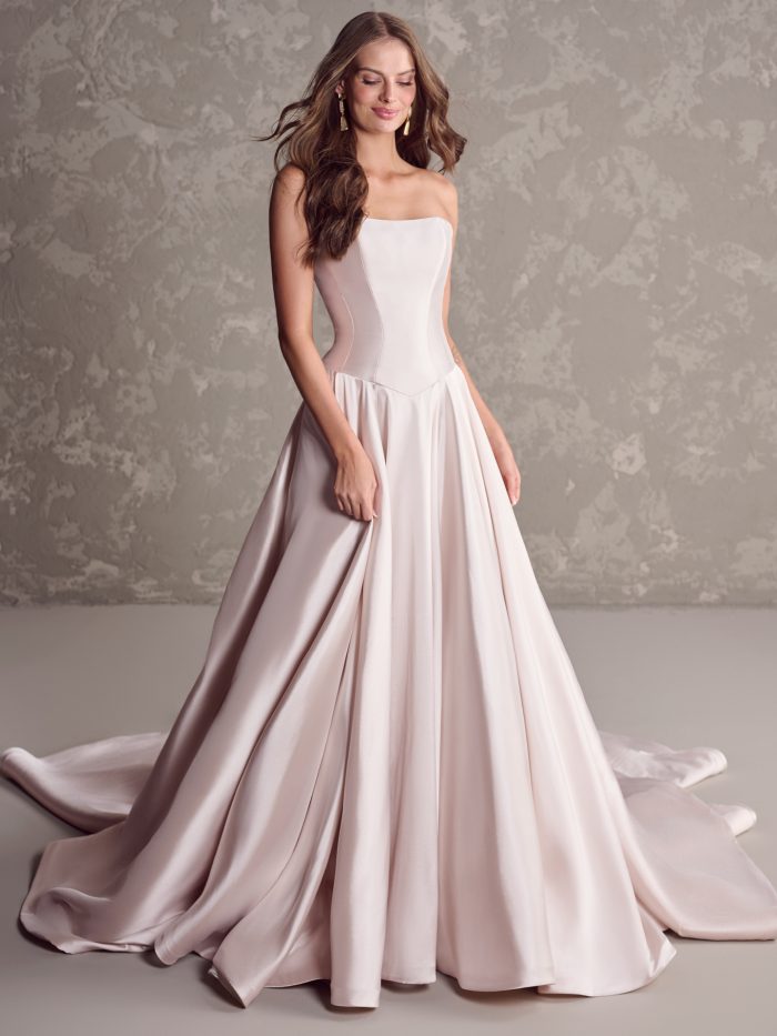 Emmanuelle by Maggie Sottero strapless satin ballgown wedding dress with basque waistline and full flowing skirt