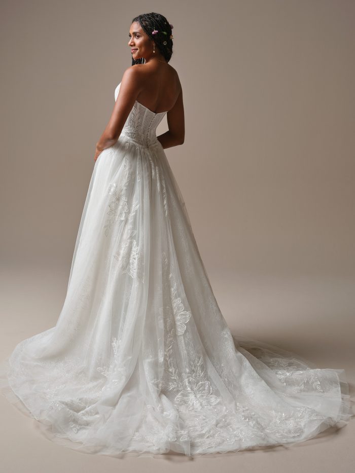 Lisa by Rebecca Ingram strapless ballgown wedding dress featuring lace appliqué detailing and a flowing tulle train